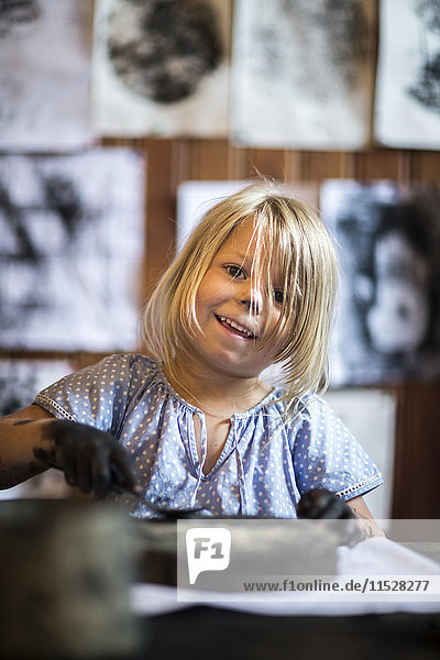 Blond girl during art classes
