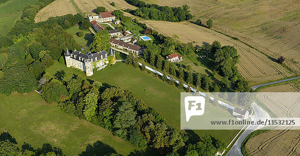 France  Dordogne  aerial view of La Cote Castle and its outbuildings  surrounded by fields and a forest