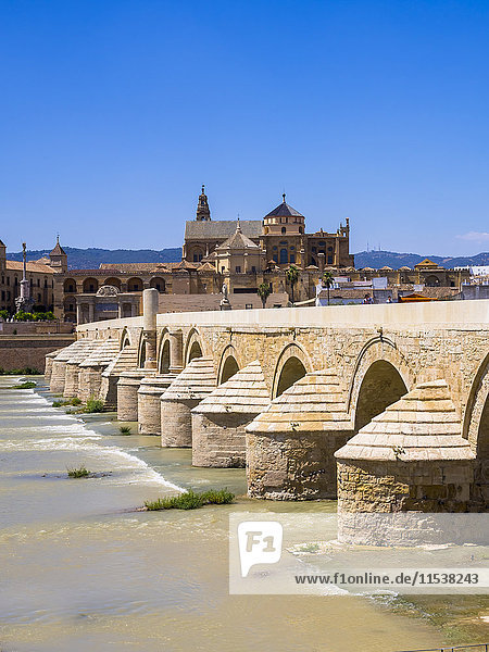 Spain,  Andalusia,  Cordoba,  Puente Romano over Rio Guadalquivir with Mezquita-Catedral in background