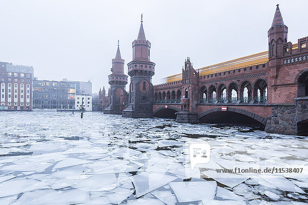 Germany Berlin view to Oberbaum Bridge with driving underground train in winter