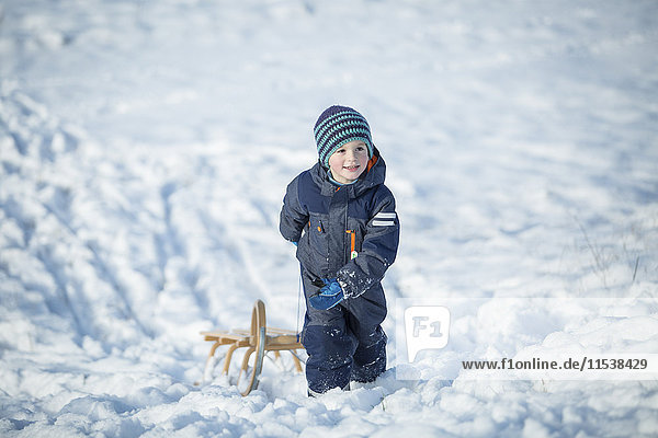Little boy with sledge