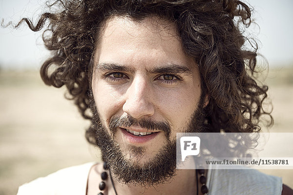 Portrait of man with beard and curly hair