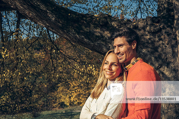 Happy couple enjoying autumn forest