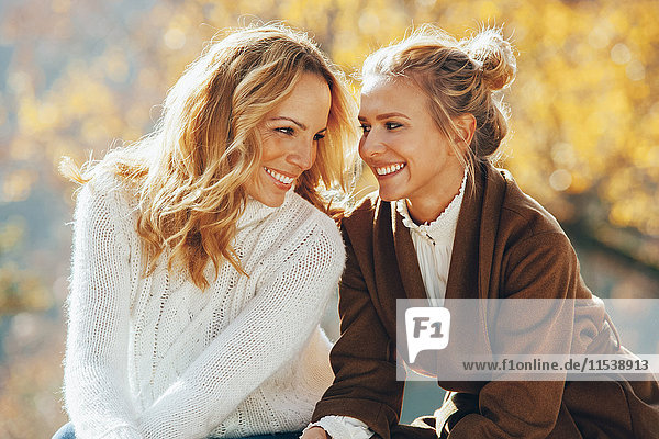 Happy mother and adult daughter in autumn
