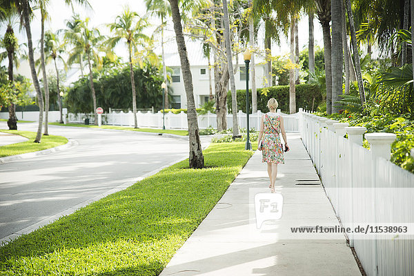 USA  Florida  Key West  woman walking on sidewalk
