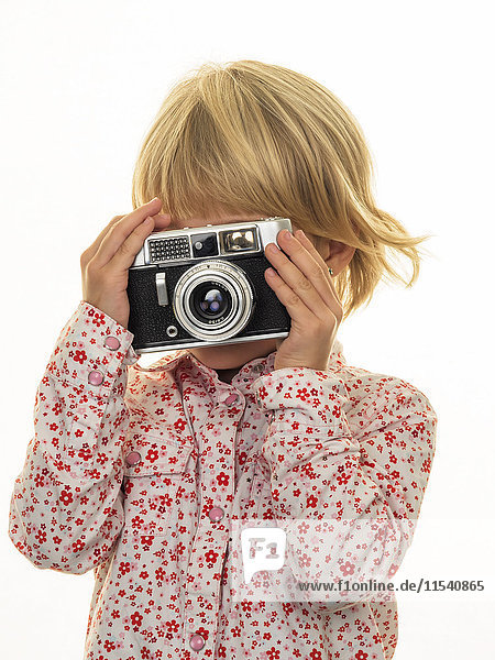 Girl taking picture with old-fashioned camera