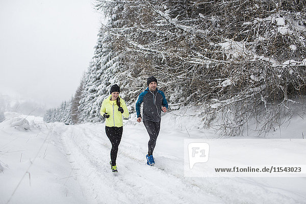 Couple doing cross country run in winter