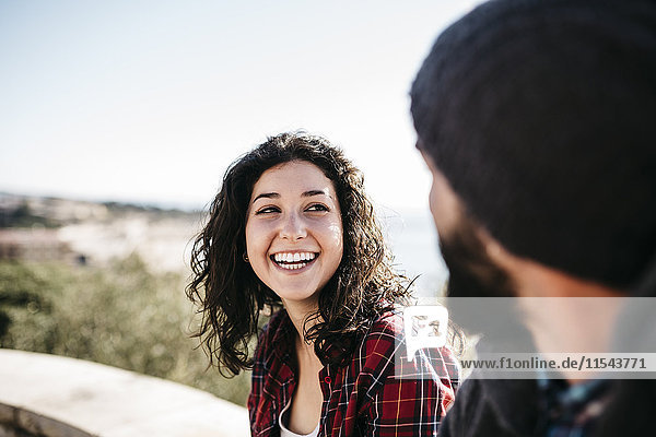 Happy young woman looking at boyfriend outdoors