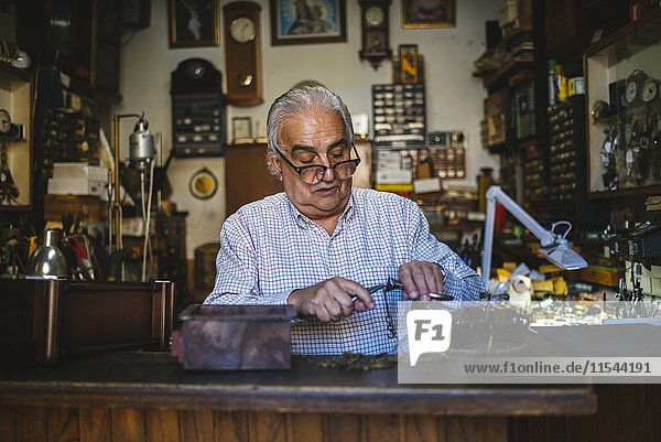 Watchmaker working in watchmaking