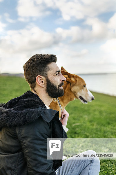 Man and his dog on a meadow