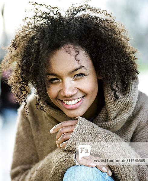 Portrait of smiling young woman with afro