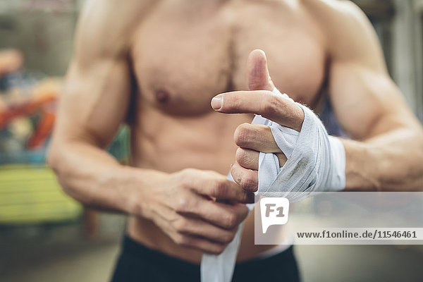 Boxer bandaging his hand