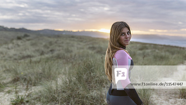 Young surfer woman on the beach
