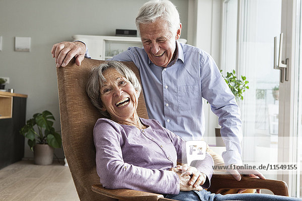 Laughing senior couple at home