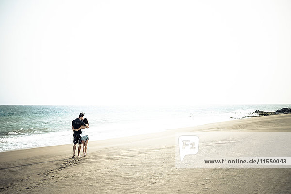 Couple in love walking on the beach