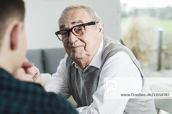 Portrait of happy senior man communicating with his grandson
