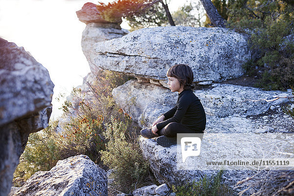 Spain  Siurana  little boy relaxing on a rock