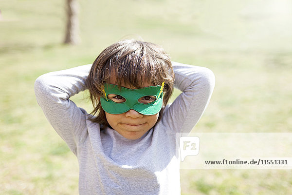 Portrait of little boy wearing green eye mask