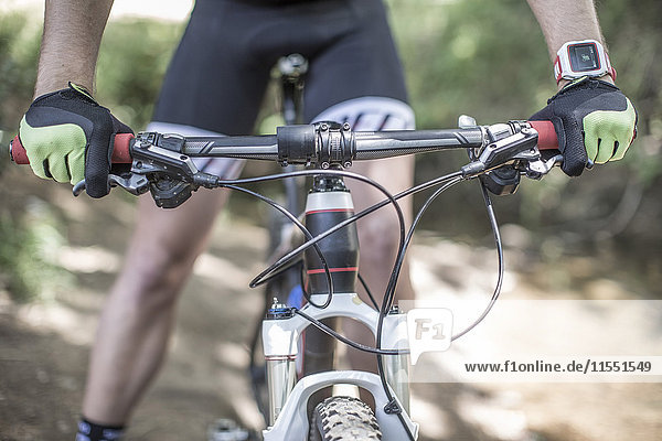 Close-up of man on mountainbike in forest