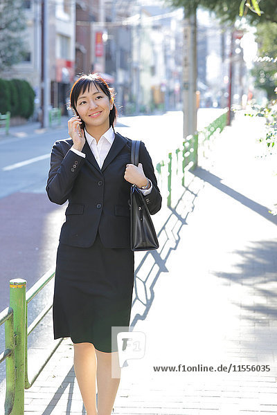 Japanese young businesswoman on the phone downtown Tokyo