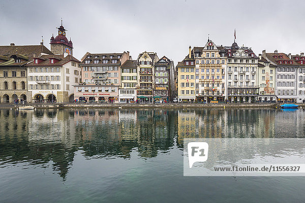 The typical buildings of the old medieval town are reflected in River Reuss  Lucerne  Switzerland  Europe