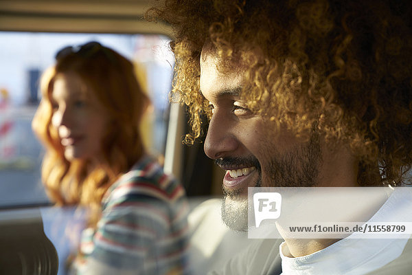 Smiling young man with girlfriend in a car