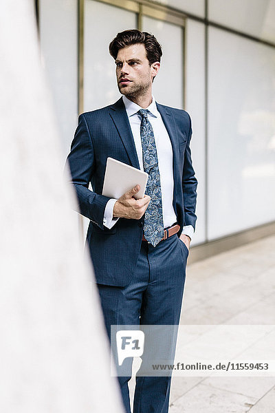 Handsome businessman using digital tablet