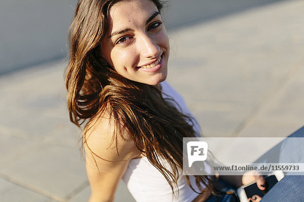 Portrait of smiling young woman at sunset