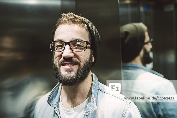 Portrait of a young man in an elevator