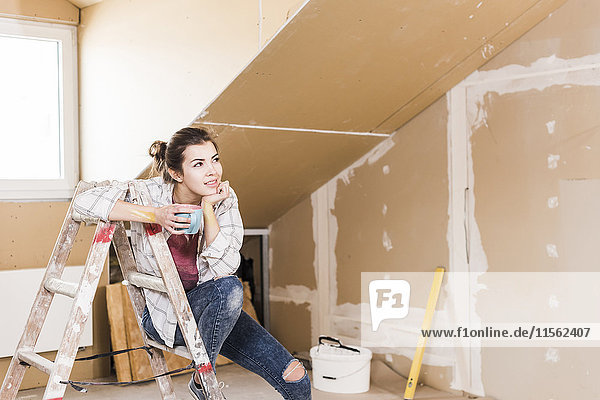 Young woman contemplating the renovation of her new home