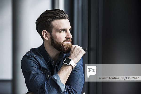 Potrait of a young businessman wearing smart watch