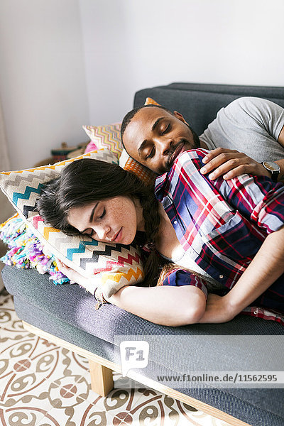 Young couple taking a nap on the sofa