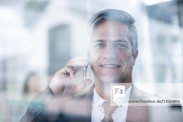Businessman in office talking on the phone