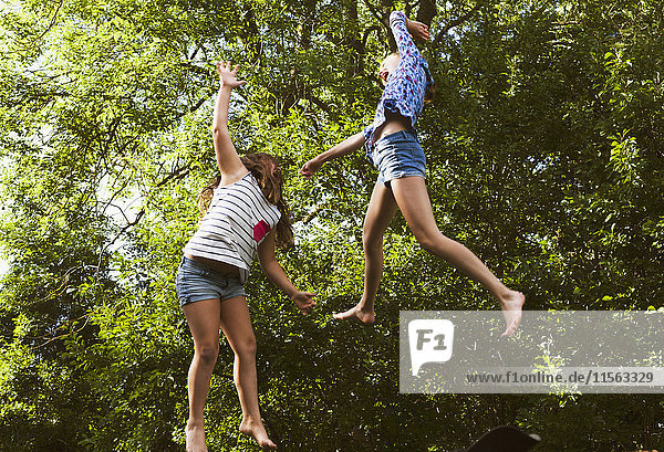 Sweden Oland Two girls (8-9 10-11) jumping