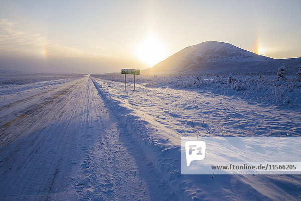 'Parhelia (sundogs) surround the sun and Donnelly Dome in this winter view of the Richardson Highway south of Delta Junction; Alaska  United States of America'