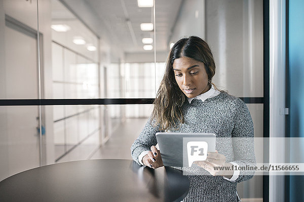 Woman using digital tablet in office