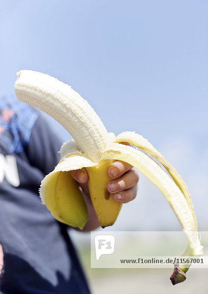 Boy holding a banana