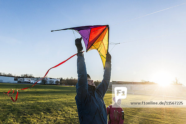 Woman and daughter flying kite