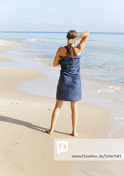 Woman standing on sandy beach