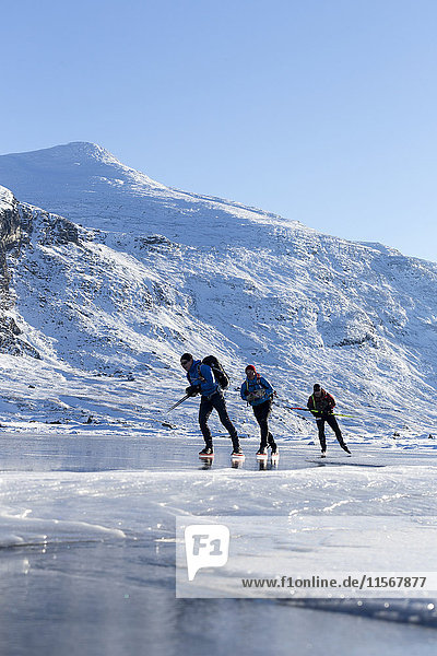 People skiing on frozen lake
