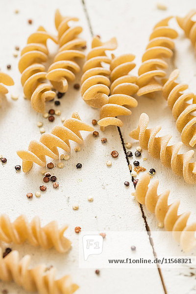 Pasta and quinoa on white background