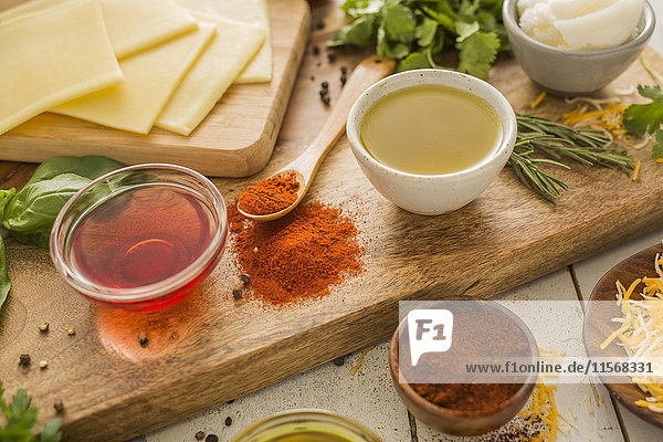 Spices  olive oil  vinegar and cheese on cutting board
