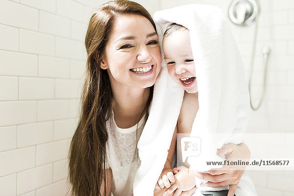 Mother and son (4-5) laughing in bathroom