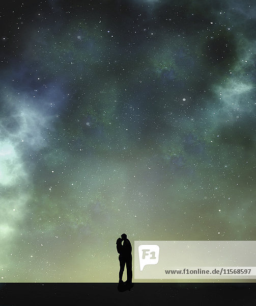 Couple kissing silhouetted against starlit sky