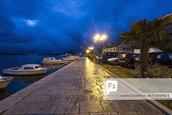 Croatia  Dalmatia  Sibenik  Empty sidewalk by harbor at dusk