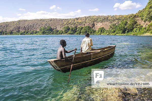 Africans in canoe Chala lake border Kenya and Tanzania