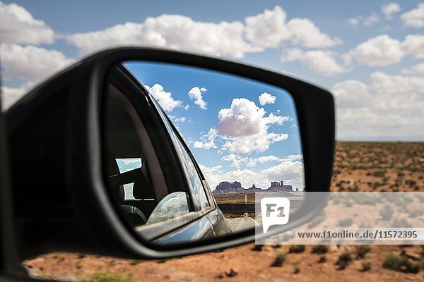 Look into the rear-view mirror of a car  Highway 163 and Monument Valley  Mexican Hat  Utah  USA  North America