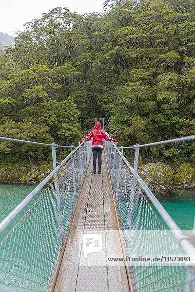 Woman crossing Suspension Bridge  Blue Pools  Haast Pass  West Coast  Southland  New Zealand  Oceania