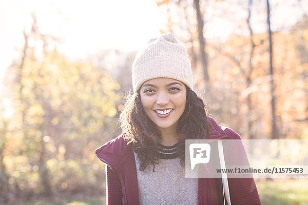Portrait of young woman wearing knit hat in autumn