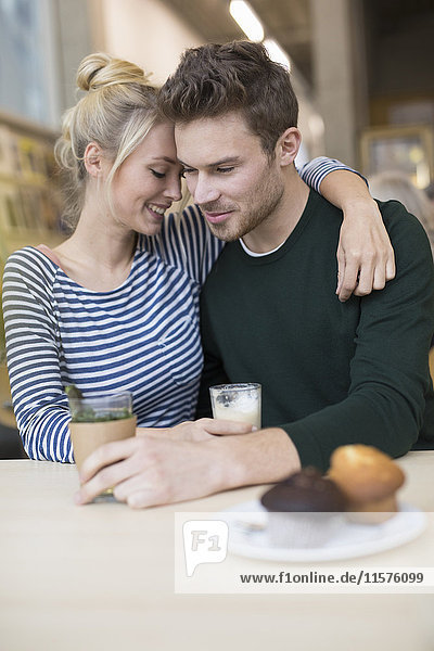 Romantic couple sitting together in cafe
